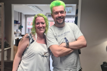 An image of a couple who have had their hair dyed green